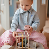 Mushie Elastic Shape Sorter i rolige naturfarver med seks former til babyer